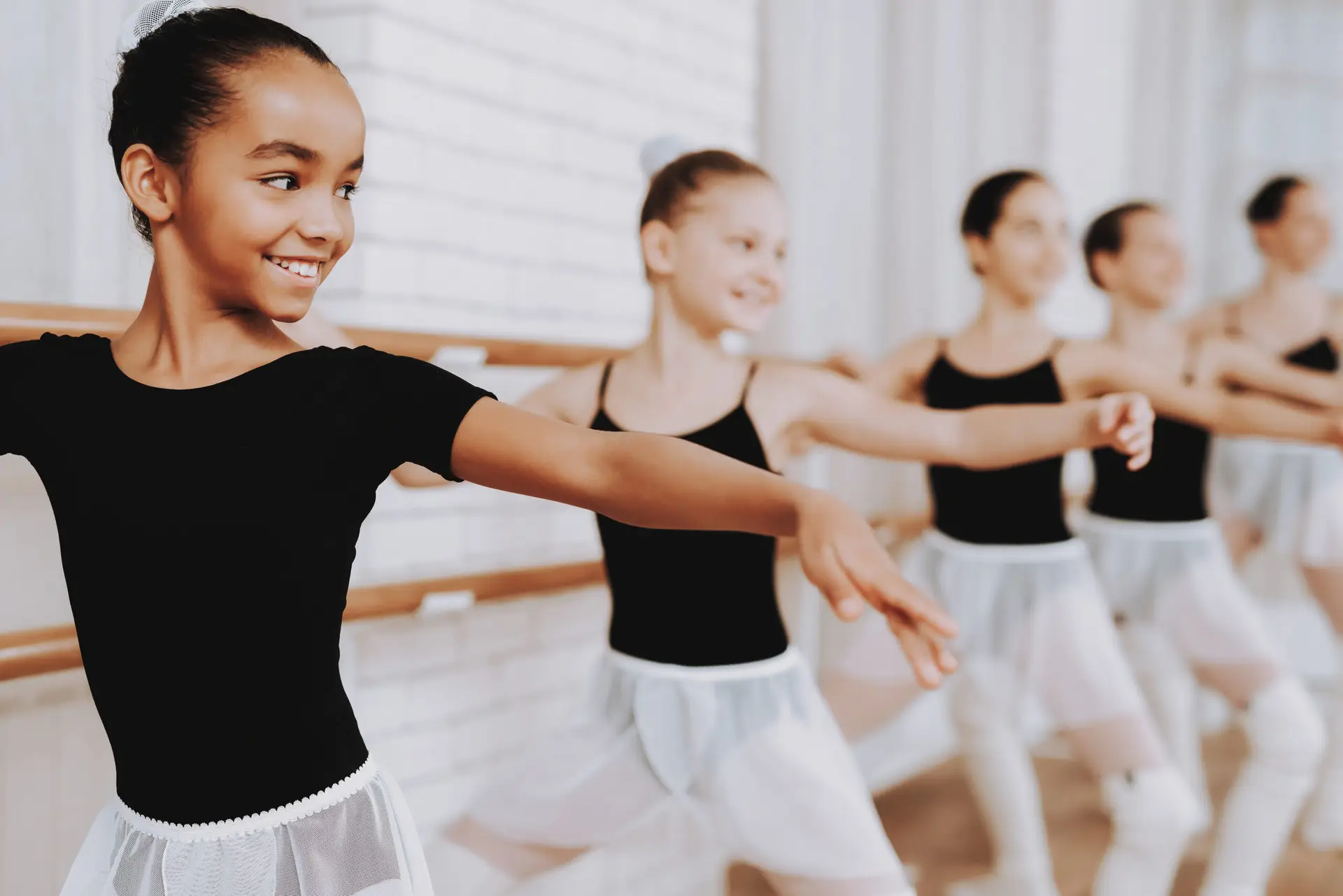 Ballet Training of Group of Young Girls Indoors. Classical Ballet. Girl in Balerina Tutu. Training Indoor. Cute Dancers. Performance in Hall. Dancing Practice. Girls in White Dresses.